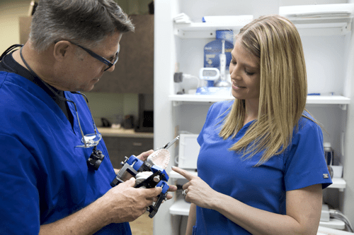 Steven Maurstad and dental assistant, inspecting model. Omaha Dentist, Restorative dentisty